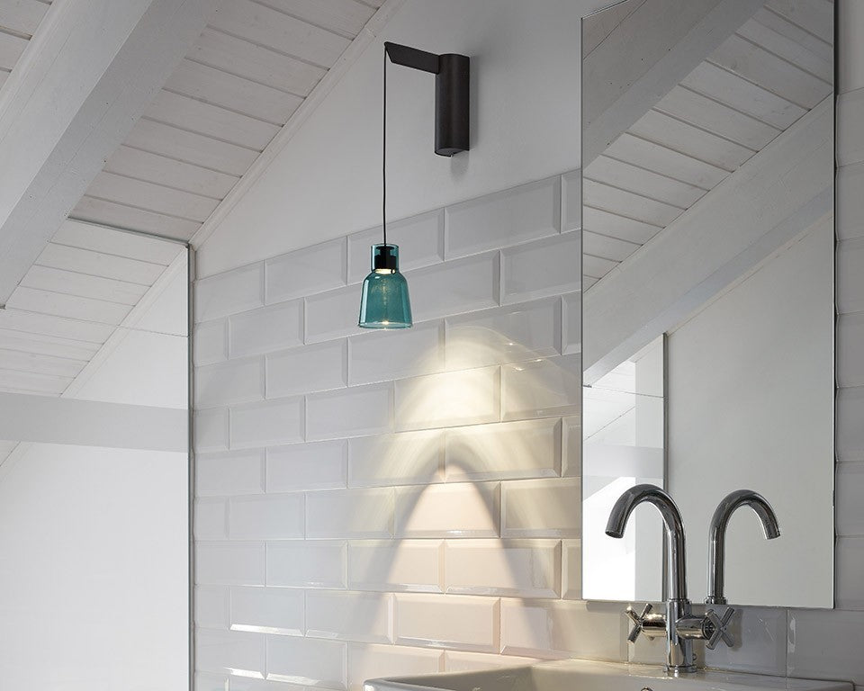 Aplique Drip A/01 Bover con pantalla de vidrio verde sobre alicatado blanco en un baño