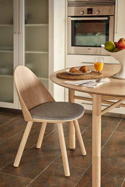 Silla UMA Teulat natural con asiento gris claro en ambiente de comedor